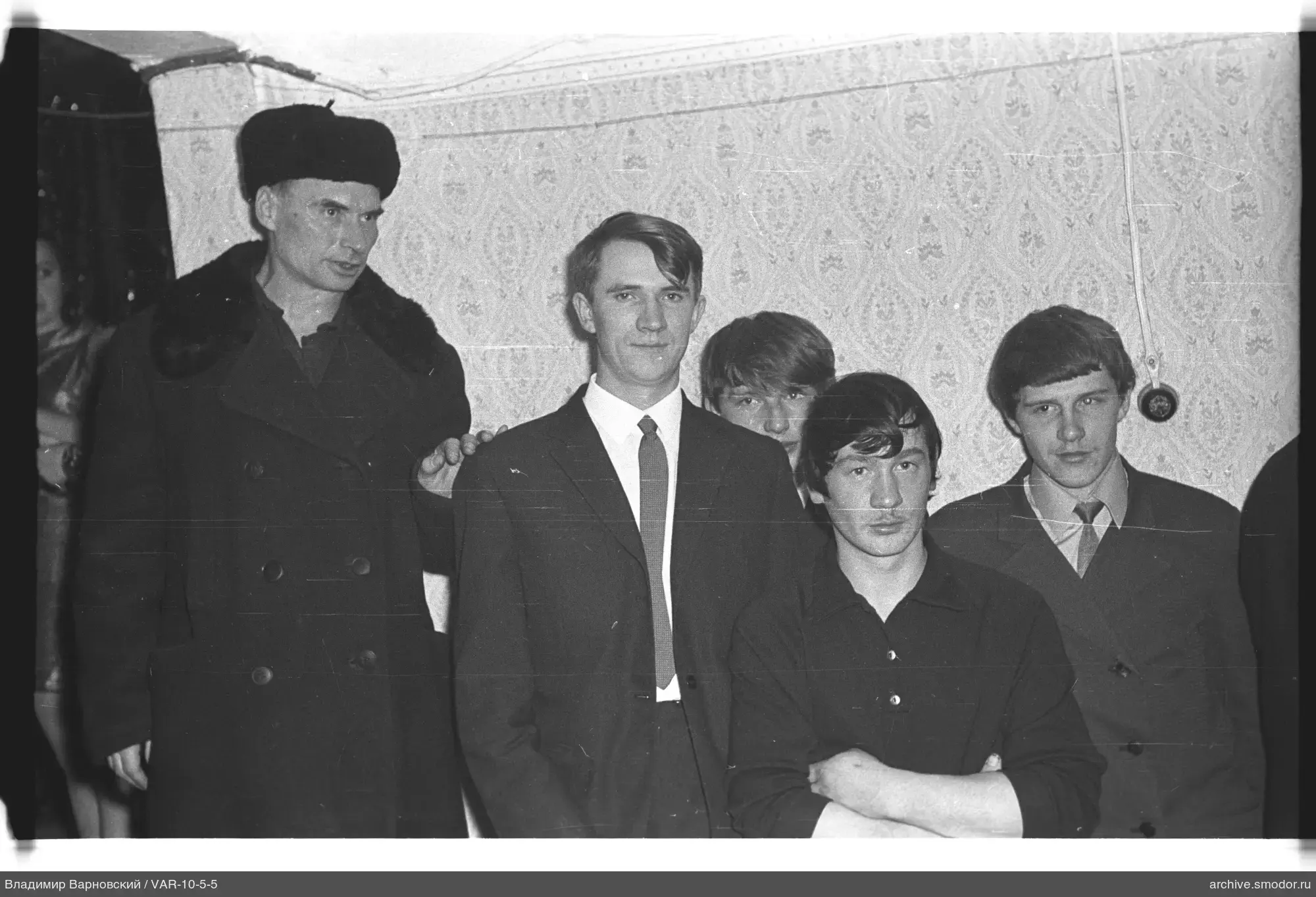 Group of men by patterned wall