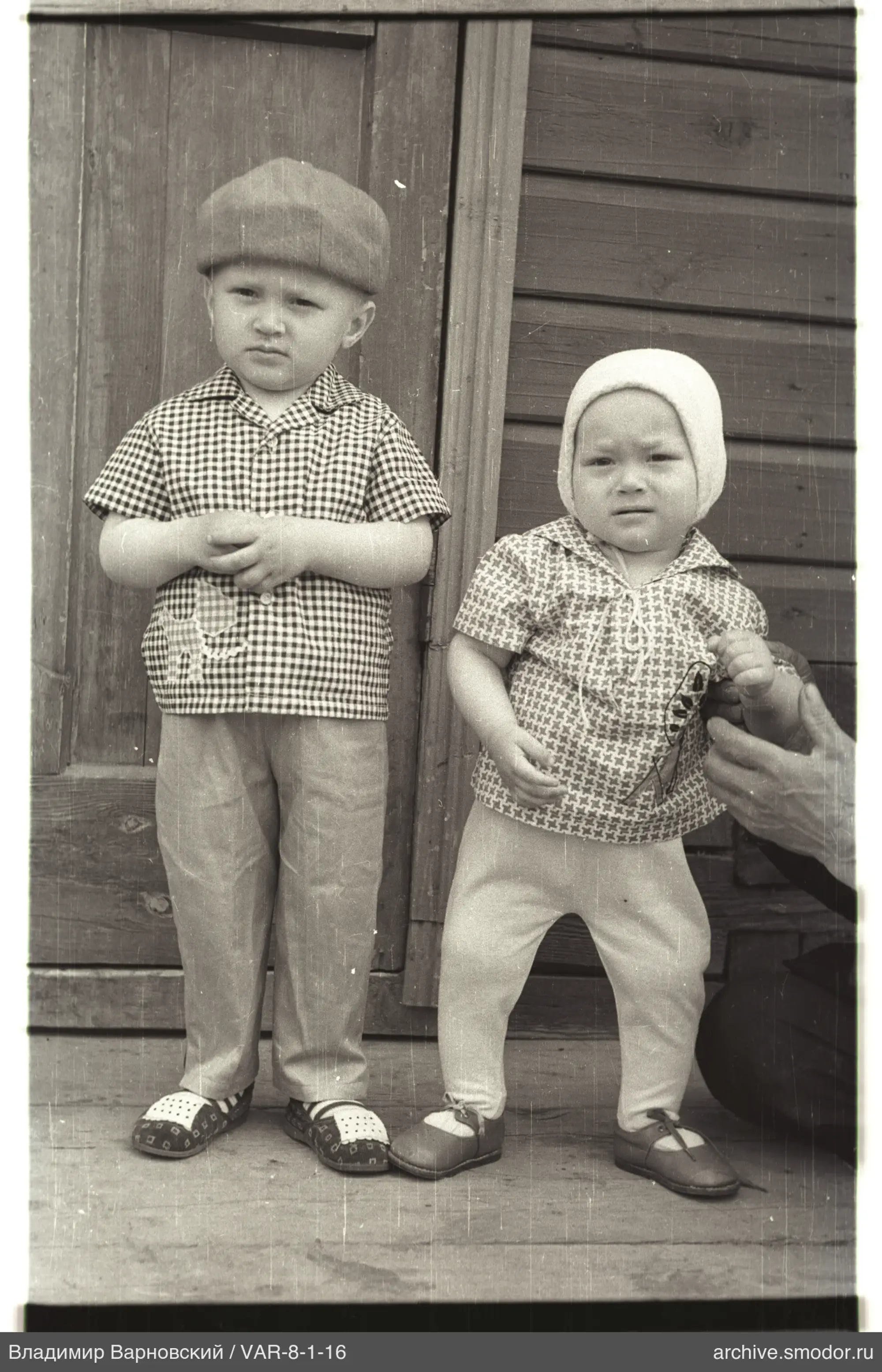Children's portrait on a wooden porch