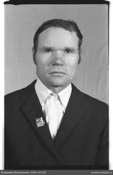 Portrait of a man with a badge on his jacket