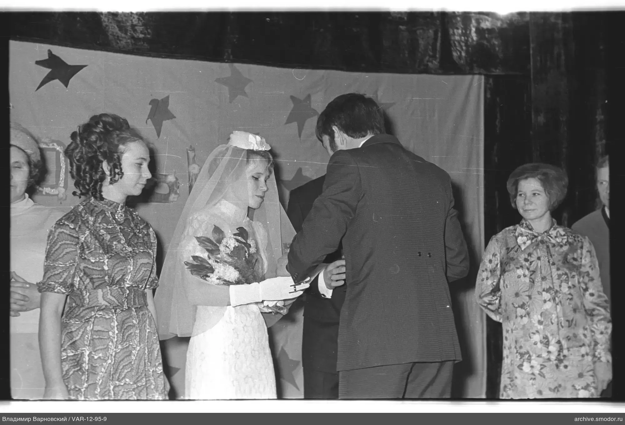 Bride with bouquet and guests