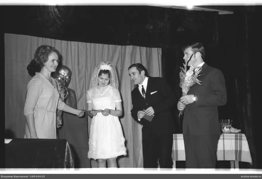 Group of four people against curtain background