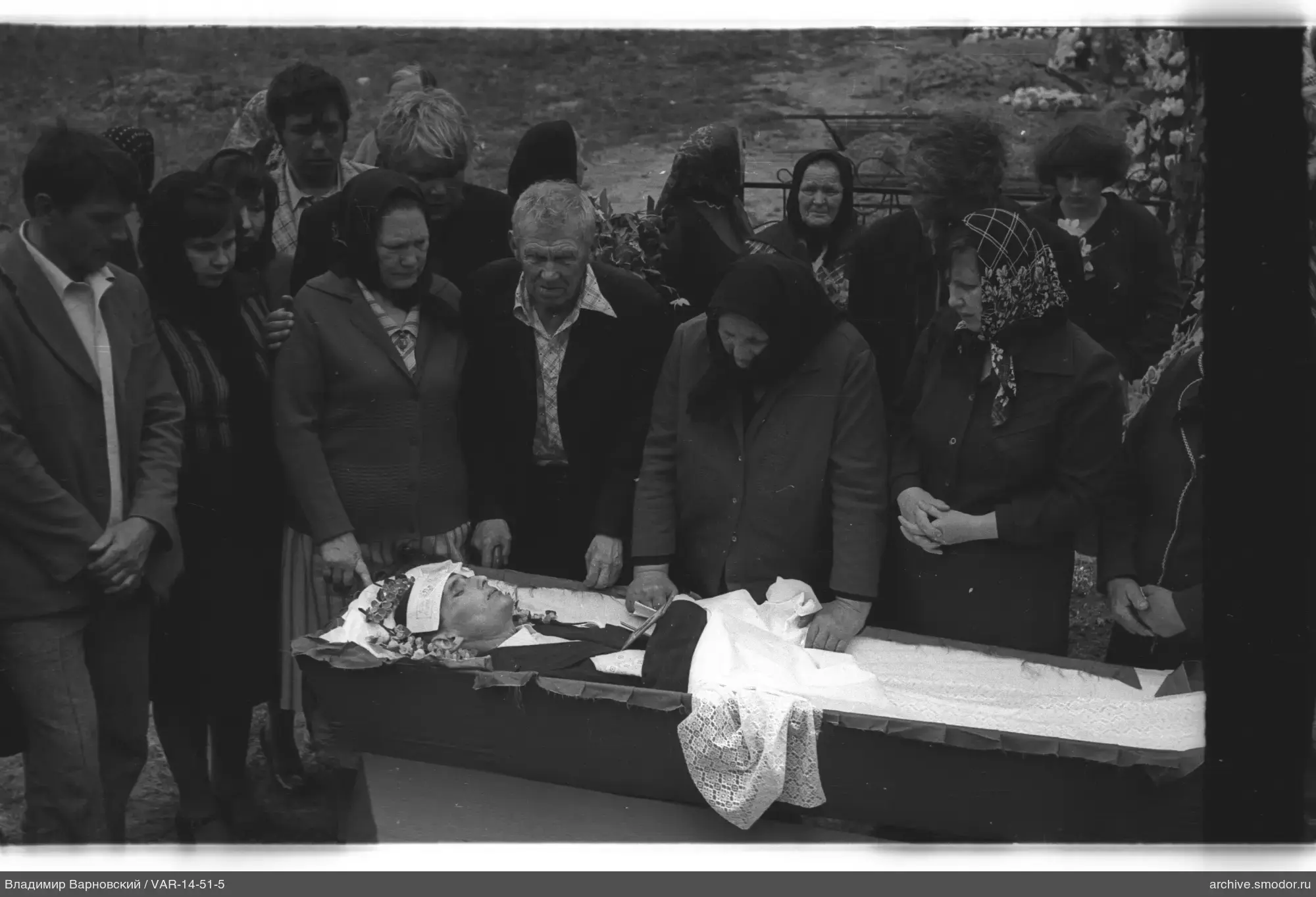 Group around an open coffin