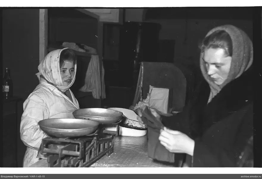 Two women with scales and a paper bag