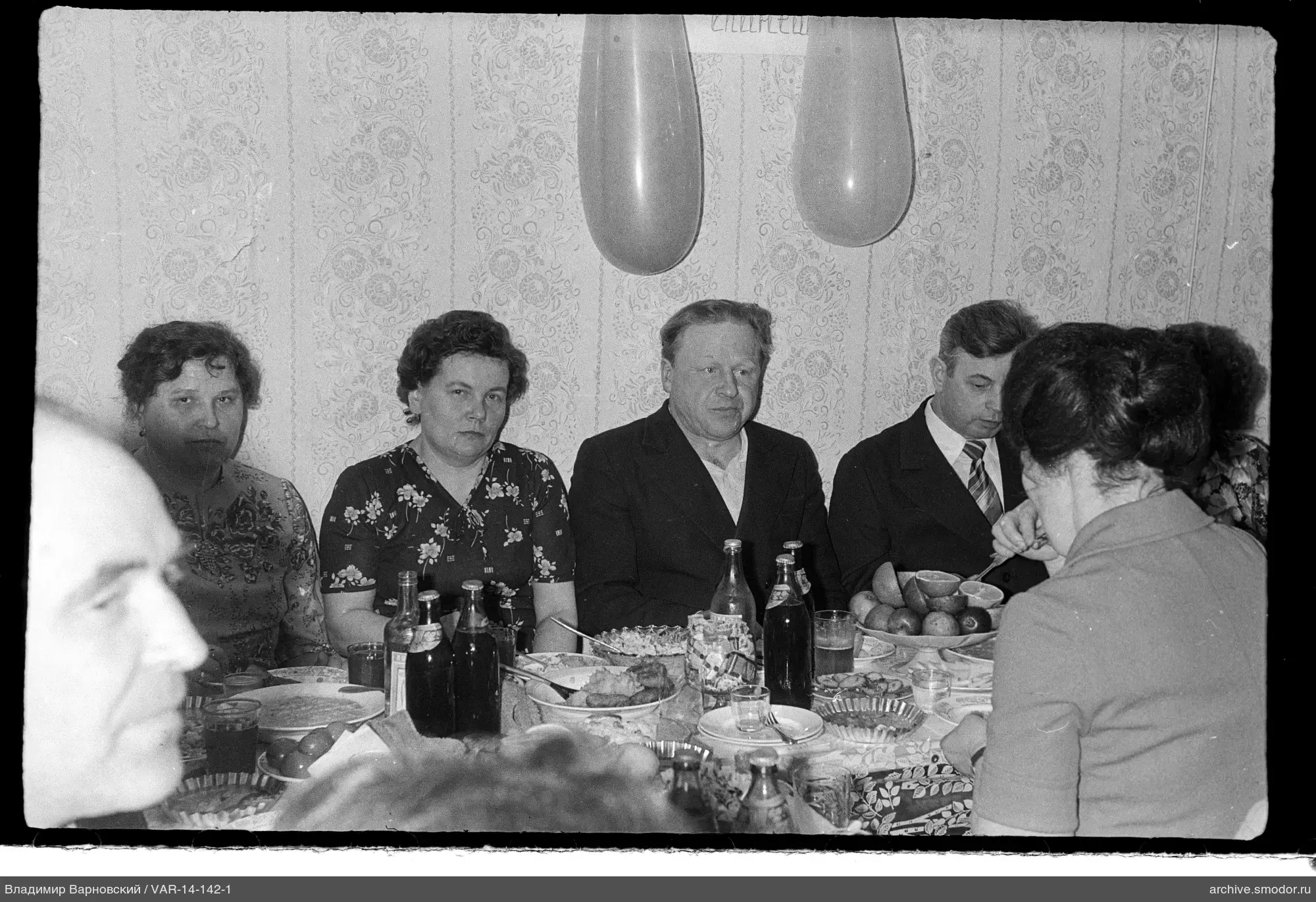 Group sitting at a table with food and drinks