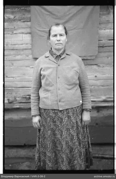 Woman in dress by wooden wall