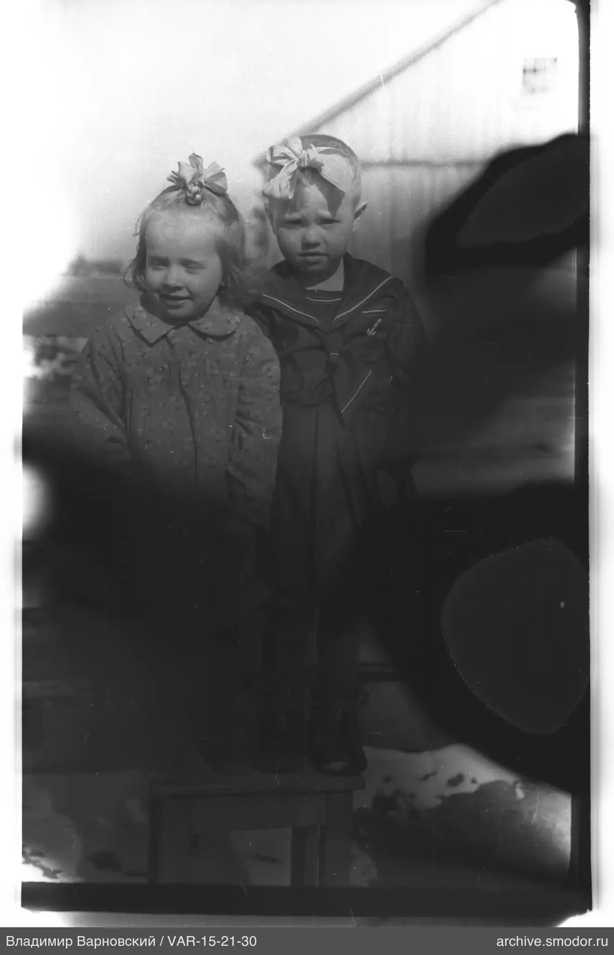 Two children on a stool