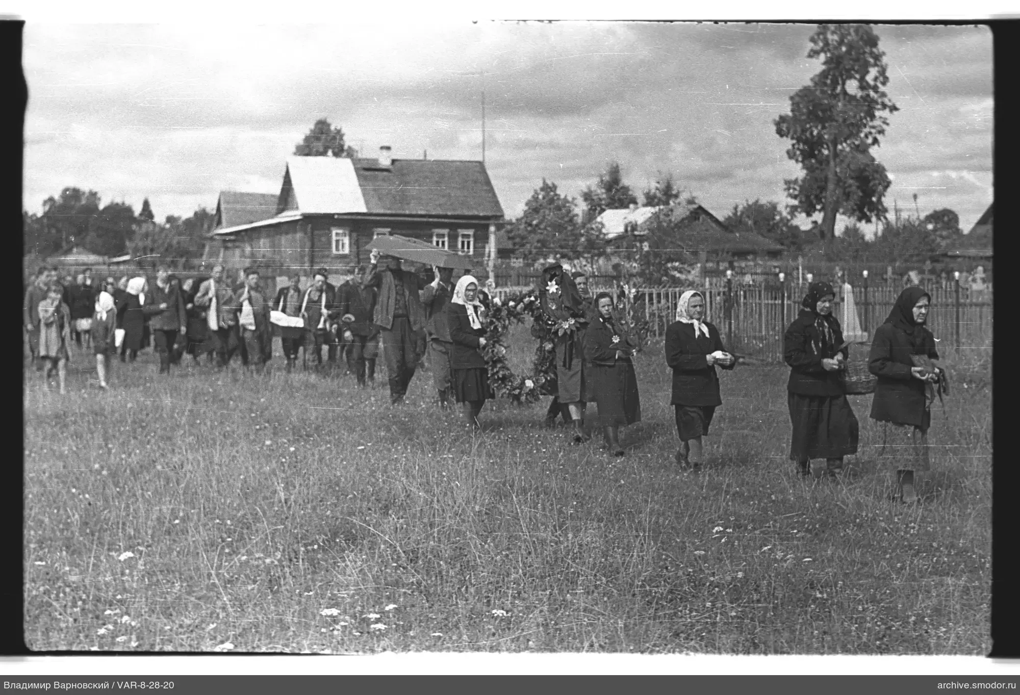 Group of people with coffin in field