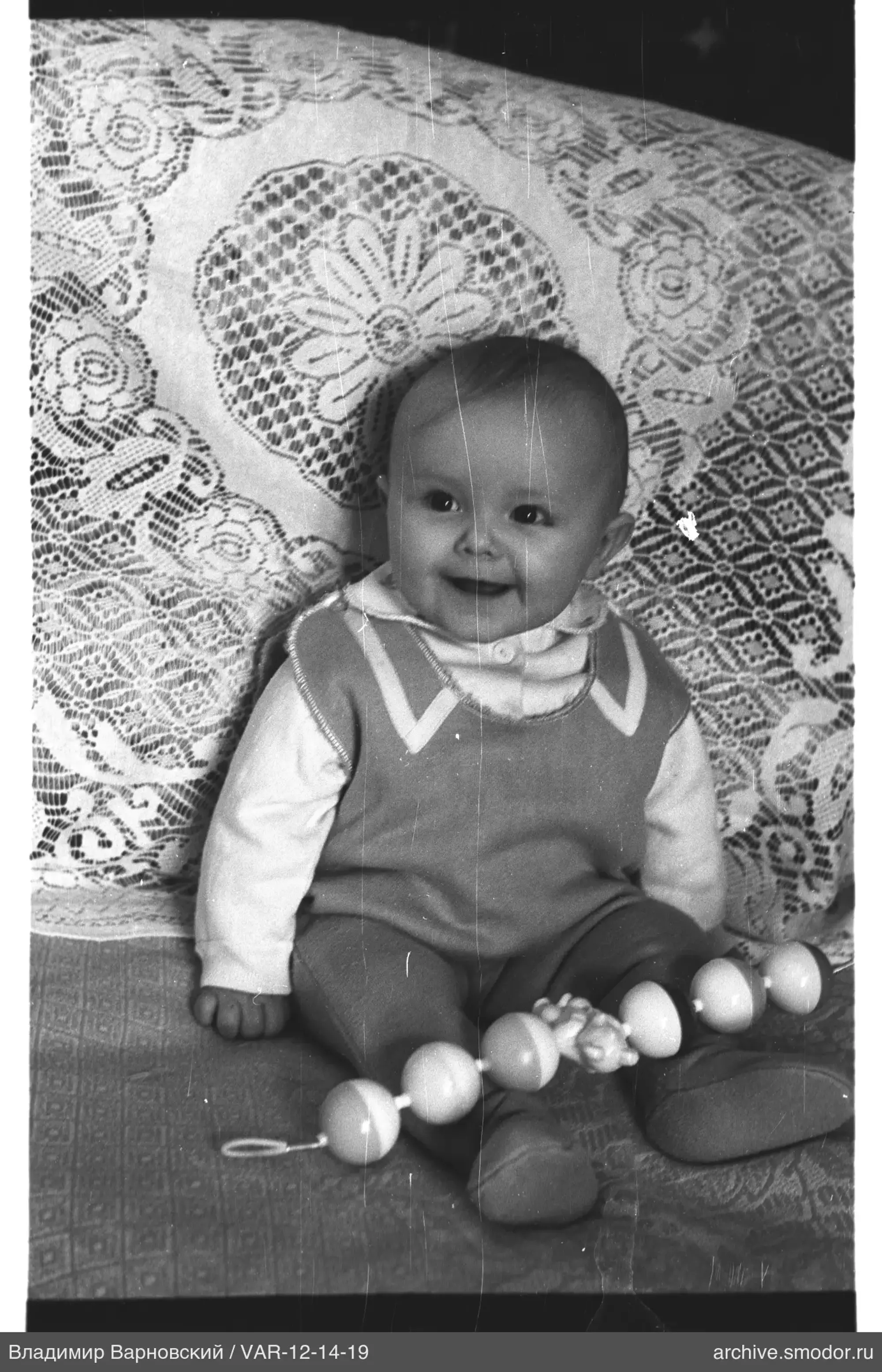 Child portrait with toy on sofa