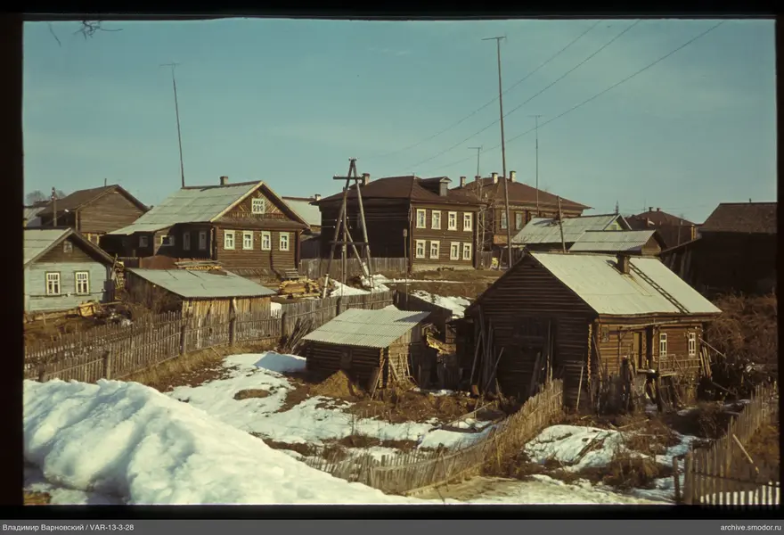 Wooden houses and antennas on a tower