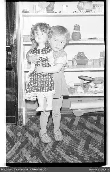 Child hugging a large doll