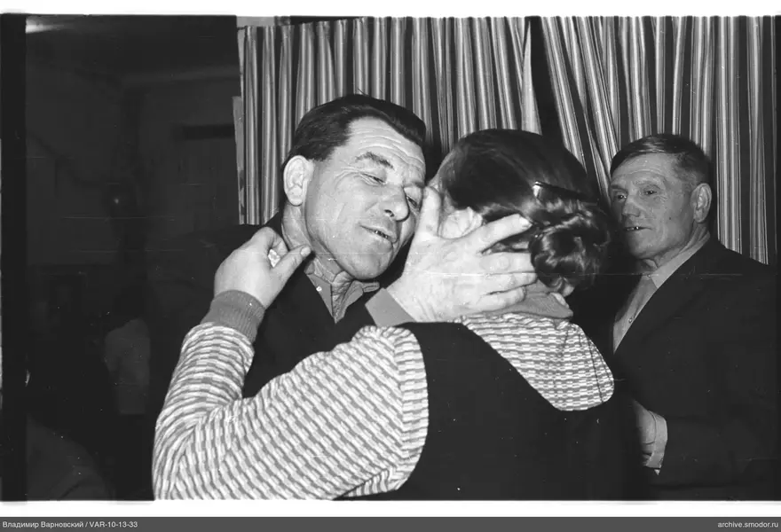 Man holding woman by the head
