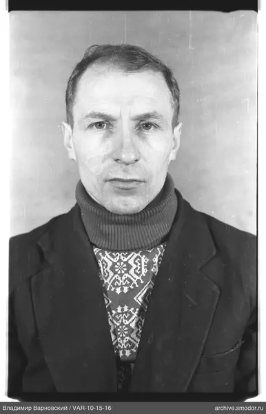 Portrait of a man in a dark jacket and sweater