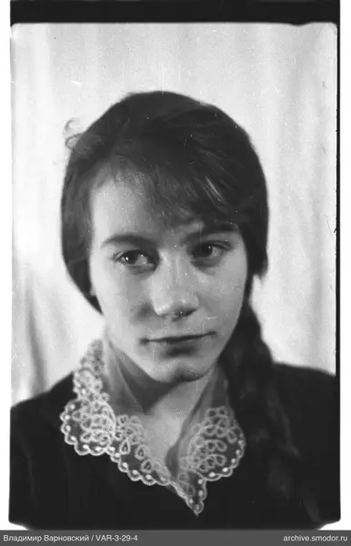 Portrait of a woman with braided hair and lace collar