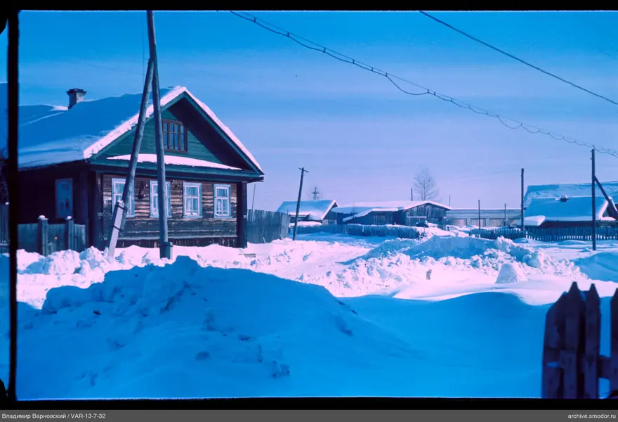 Wooden house with snow-covered roof