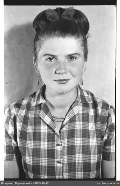 Portrait of a woman with a bun and bow