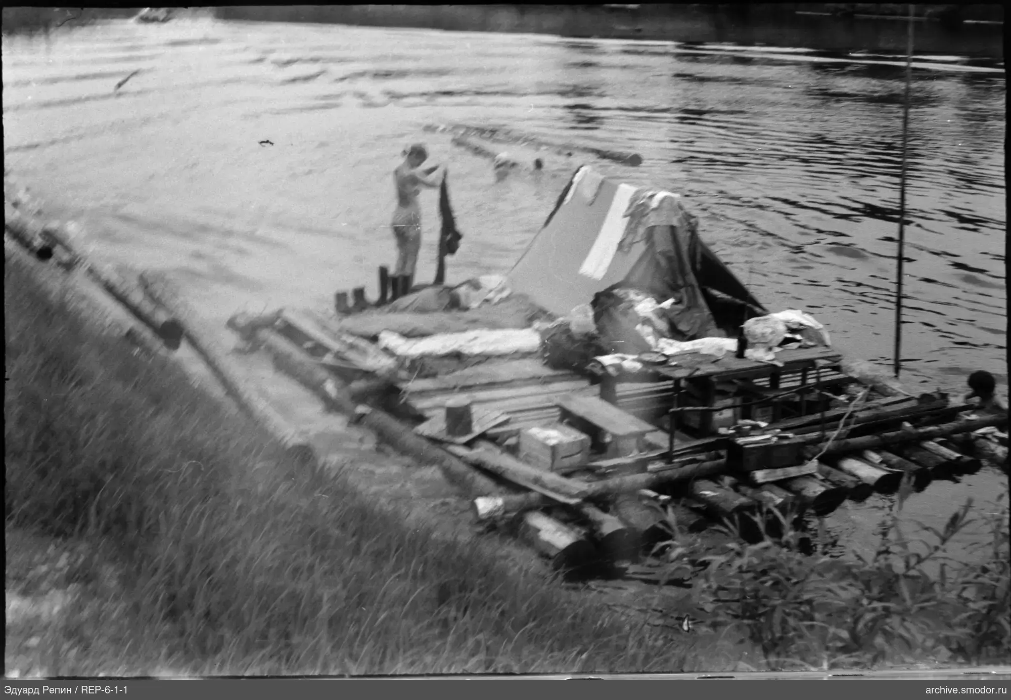 Raft with tent and people by the shore