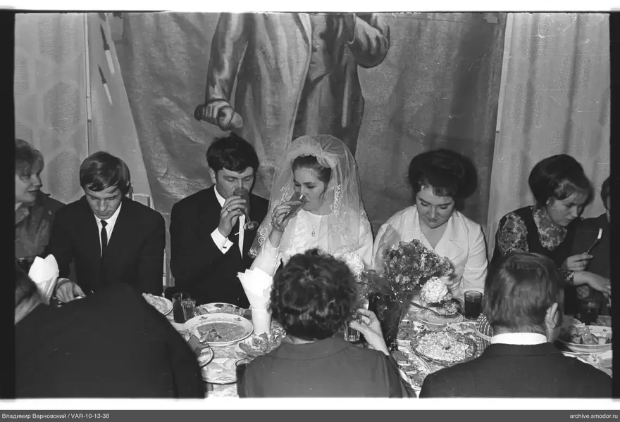 Group with woman in wedding dress at celebration