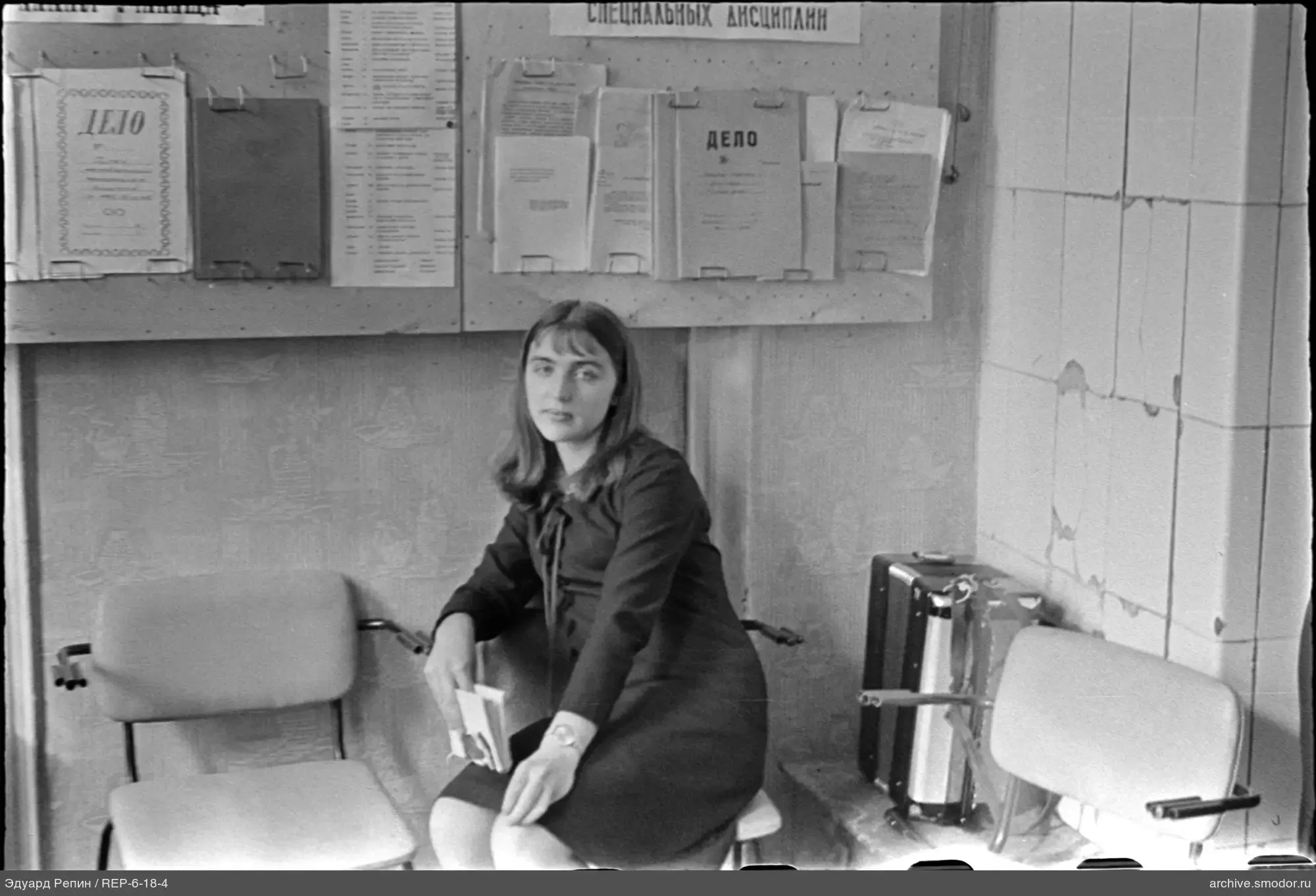 Portrait of a woman with books in a room