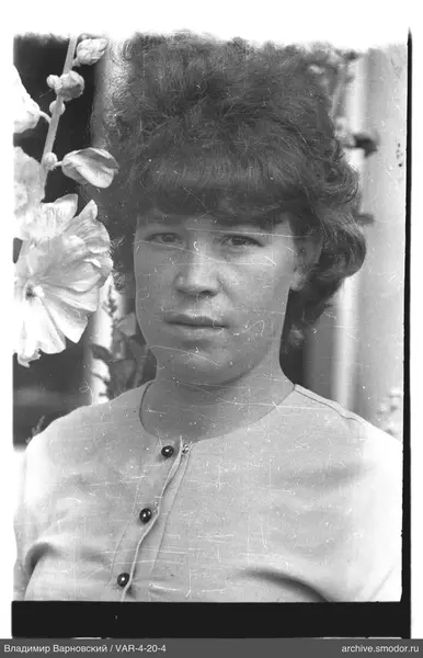 Portrait of a woman with flowers in background