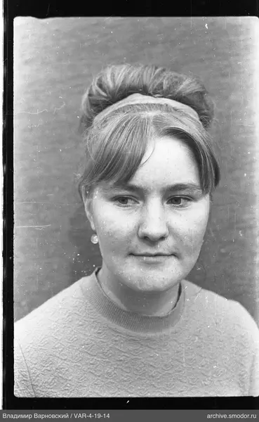 Portrait of a woman with a bun and earrings