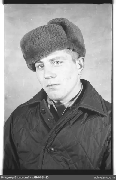 Portrait of a man in a fur hat and quilted jacket