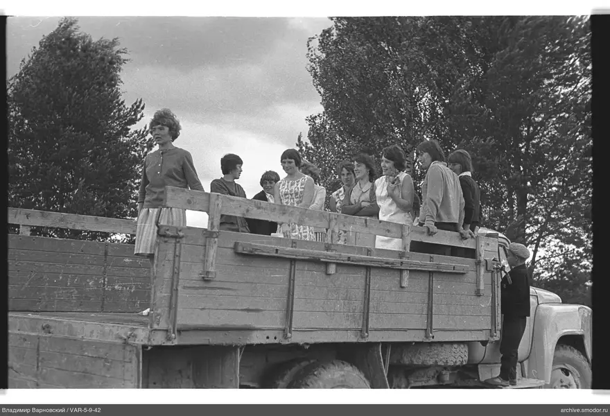 Group of girls and boy by truck