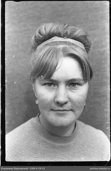 Portrait of a woman with a bun and headband