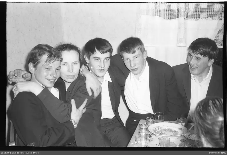 Group of people sitting at a table with dishes and glasses