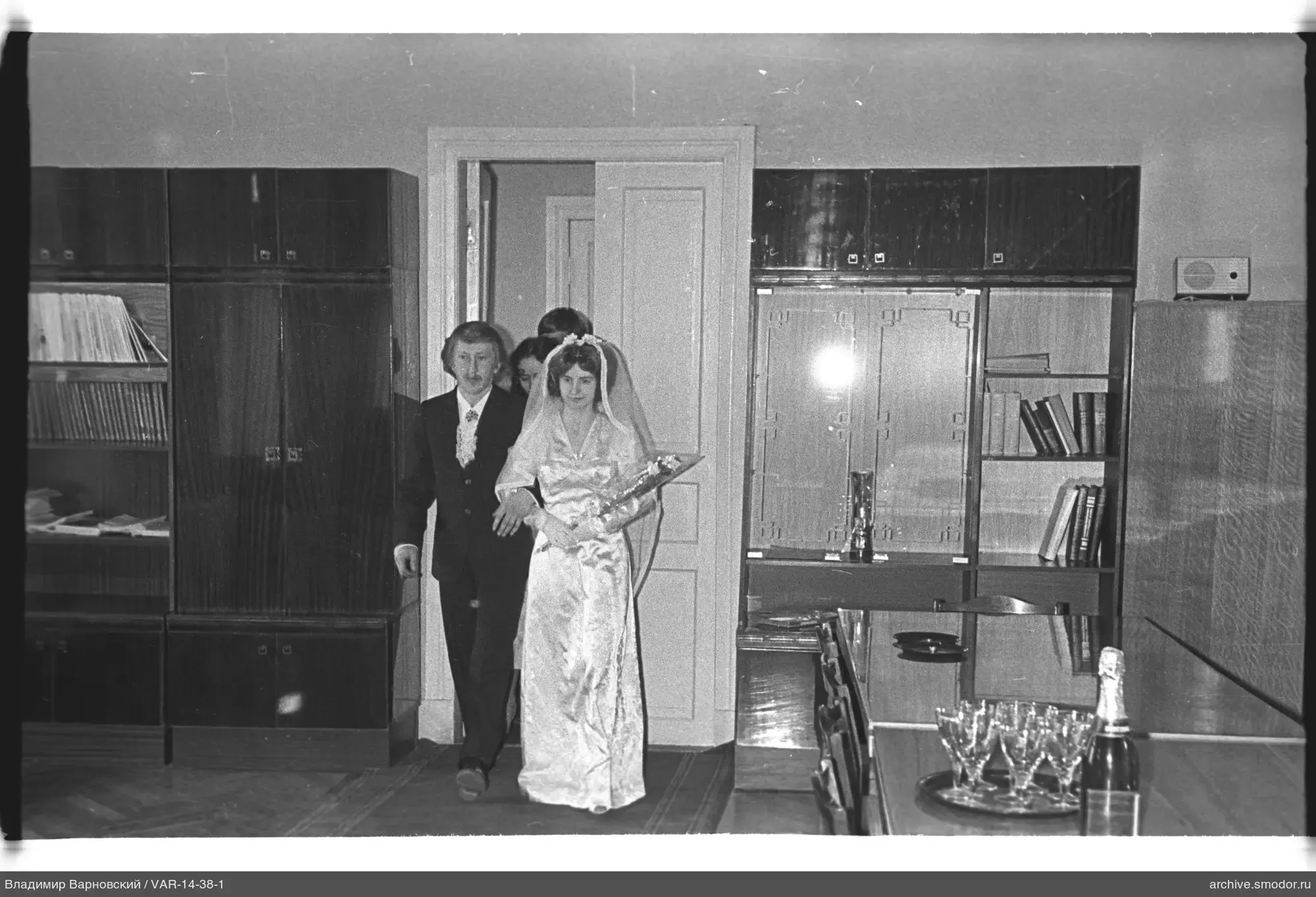 Exit from room with woman in veil and man