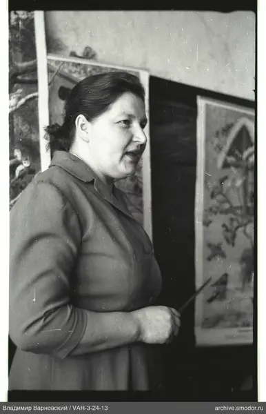 Portrait of a woman with pointer and posters