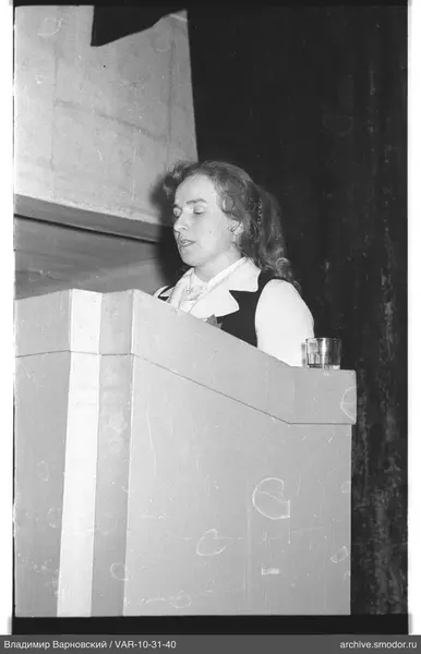 Profile portrait of a woman behind a podium