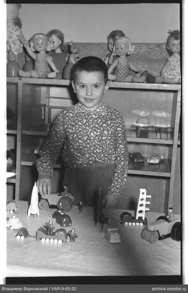 Child with toys at a shelf