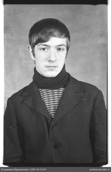 Portrait of a man in a dark jacket and sweater