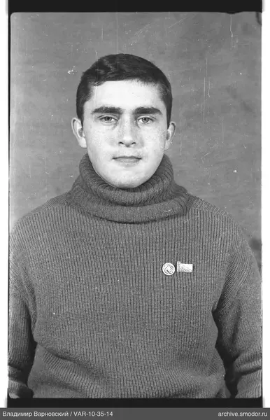 Portrait of a man in a sweater with badges