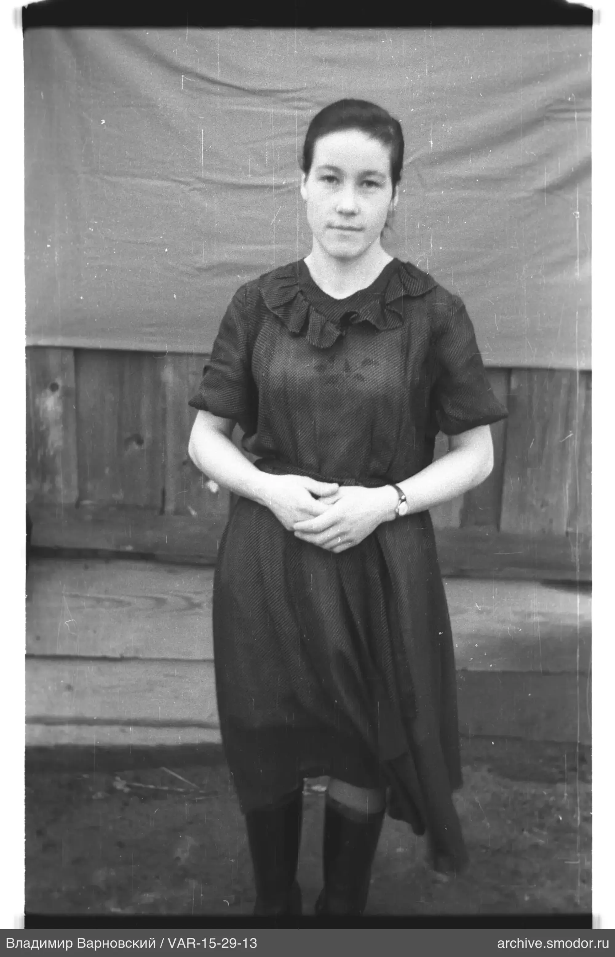 Woman in dark dress and high boots