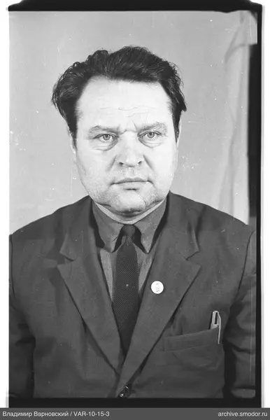 Portrait of a man in a suit with badge