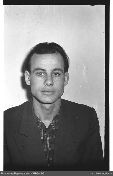 Portrait of a man in a jacket and checkered shirt