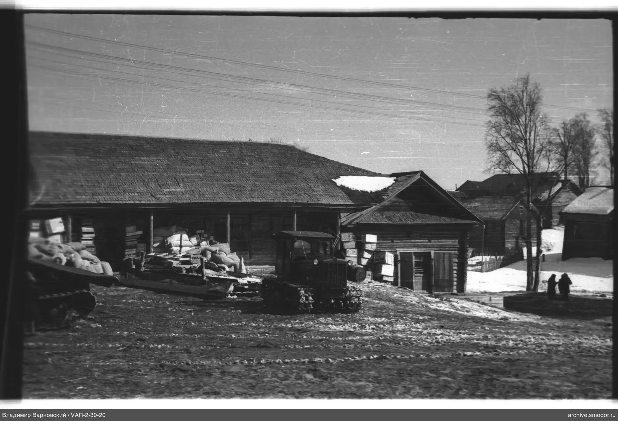 Crawler tractor and wooden building