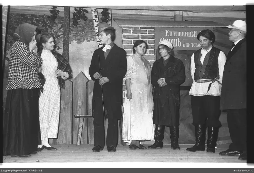 Group on stage in front of backdrop