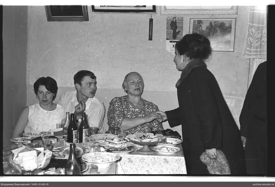 Group of people at a table with women and a man