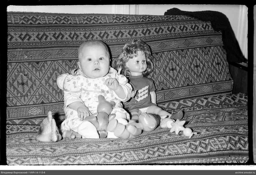 Child with toys on sofa