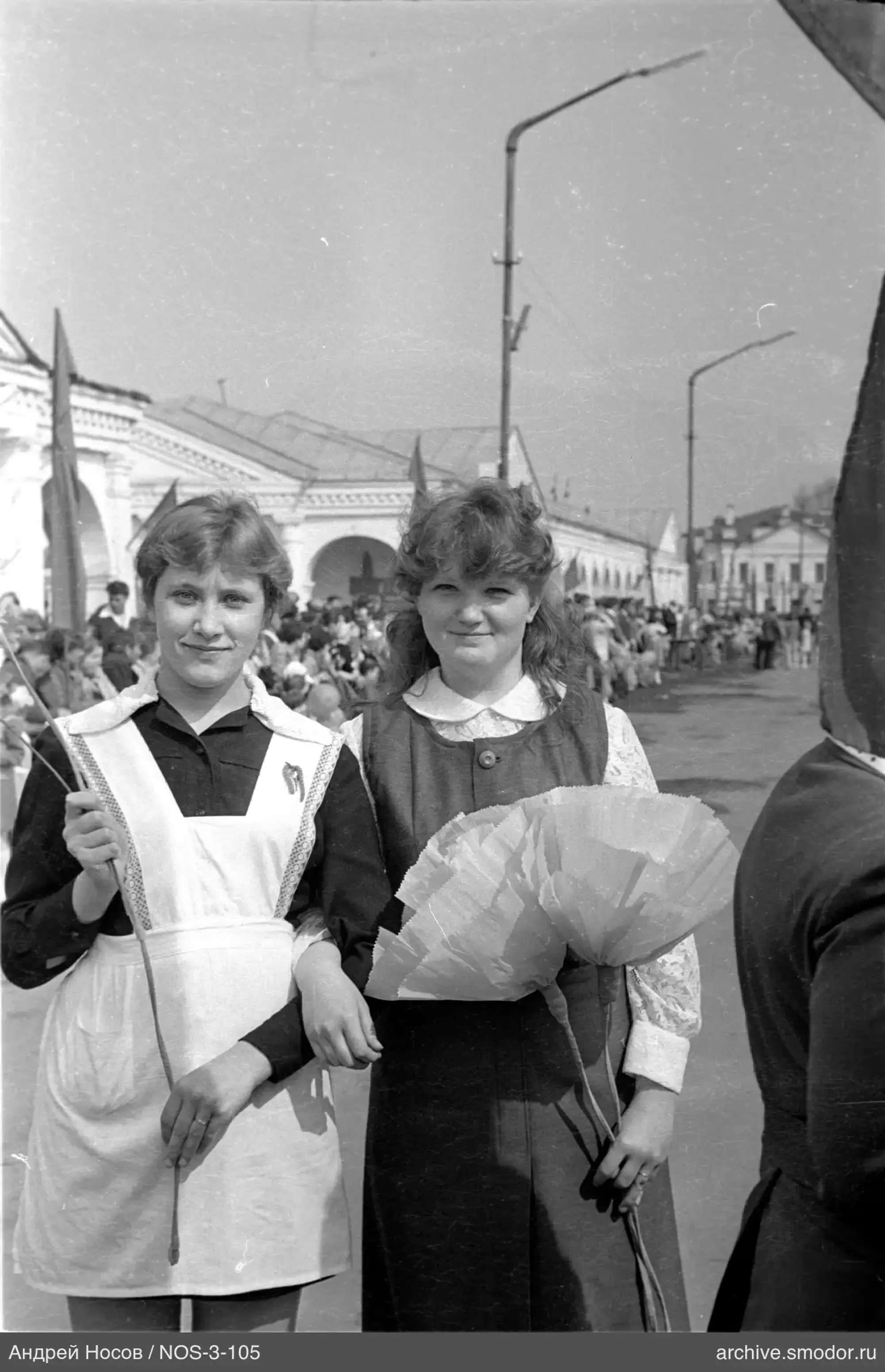 Two girls with flag and paper flowers