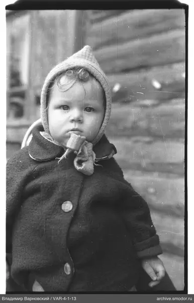 Child portrait in dark coat and headgear