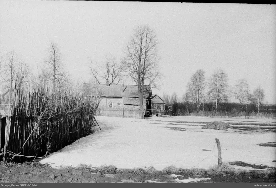 Holzhaus mit Zaun und Bäumen
