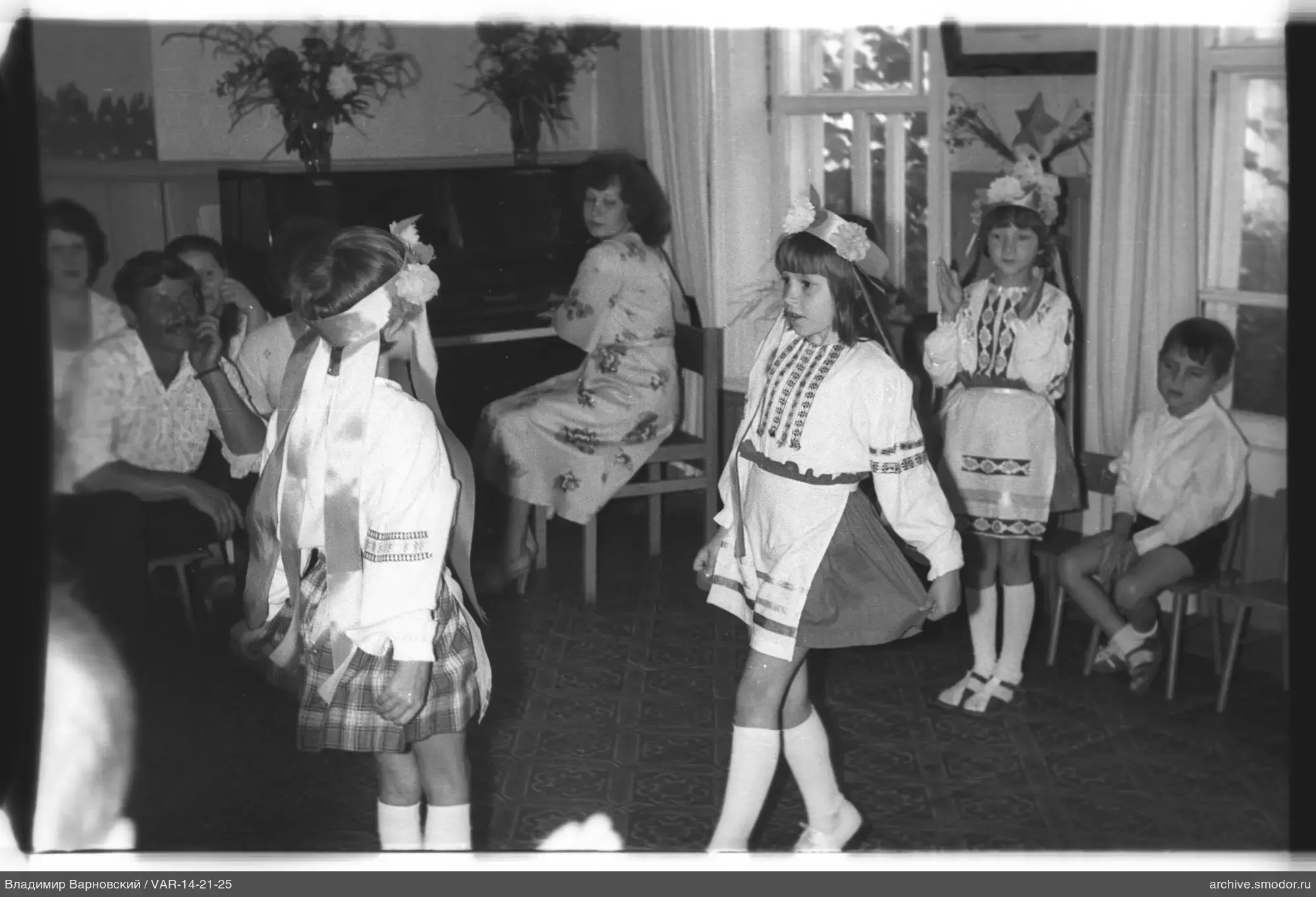 Girls in national costumes at the piano