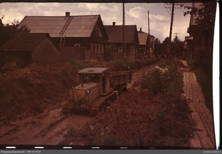 Tracked tractor moving in trench