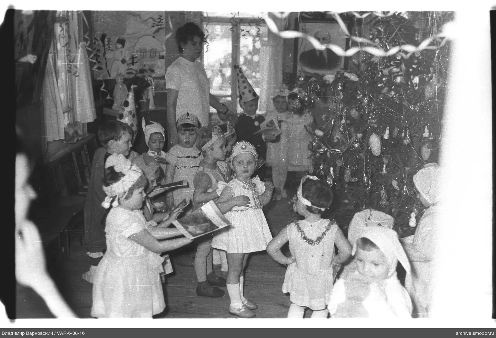 Children with books and woman at celebration