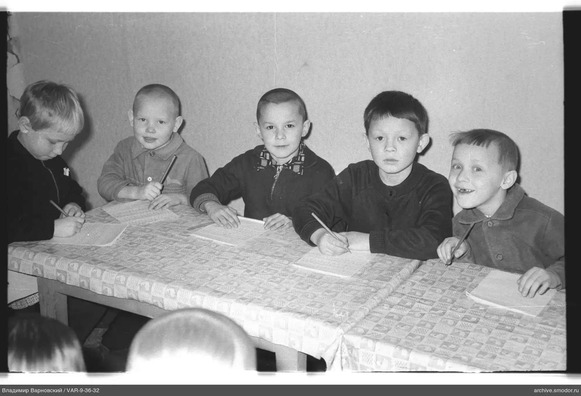 Group of boys writing at a table