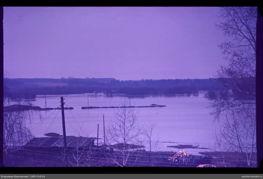 Wooden building by flood-affected river