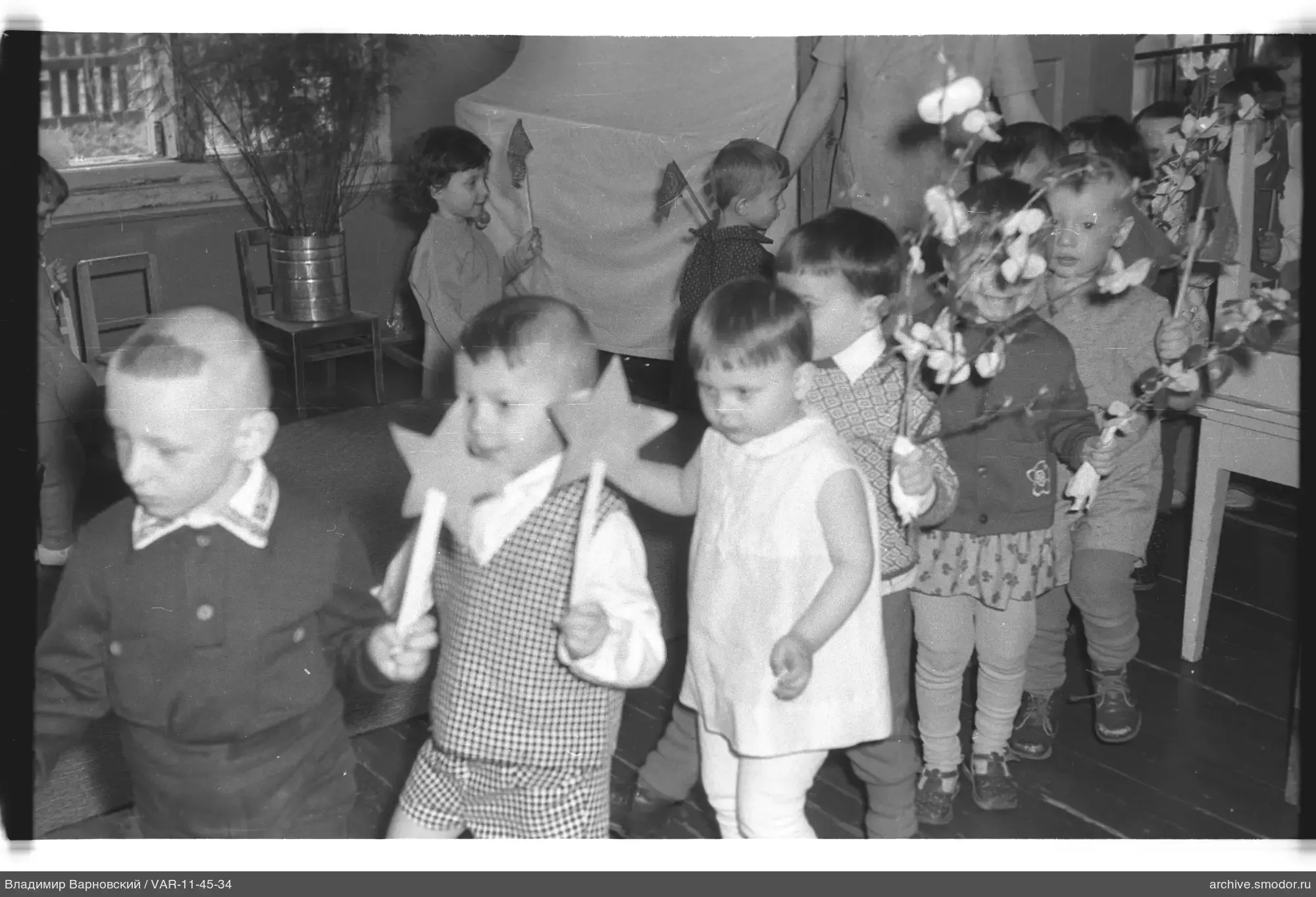 Kinder mit Papiersternen und Zweigen